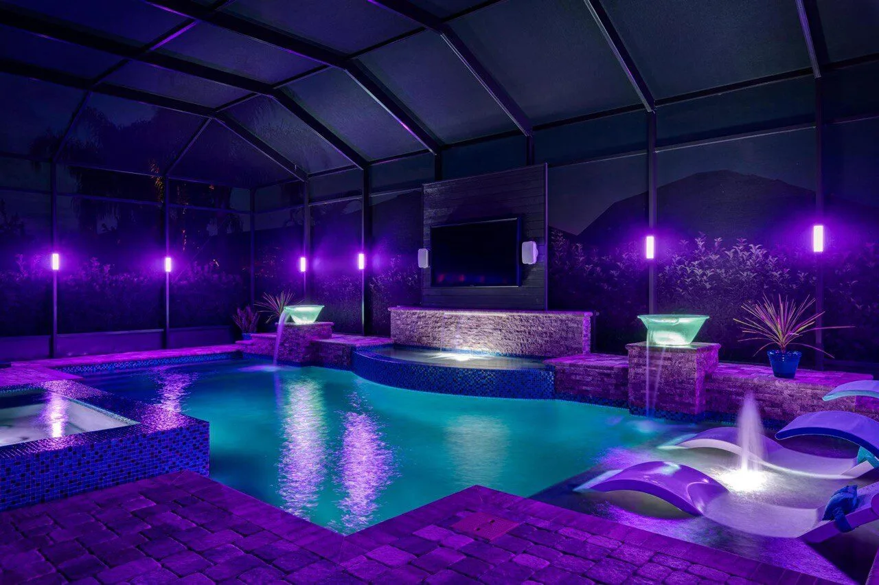 Purple LED pool cage lighting with waterfall features — installed by Superior Electrical