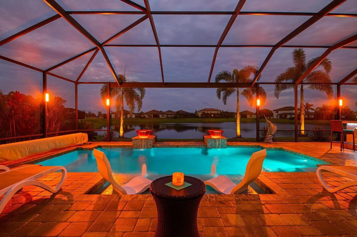 Pool cage with warm amber outdoor lighting at sunset in Sarasota